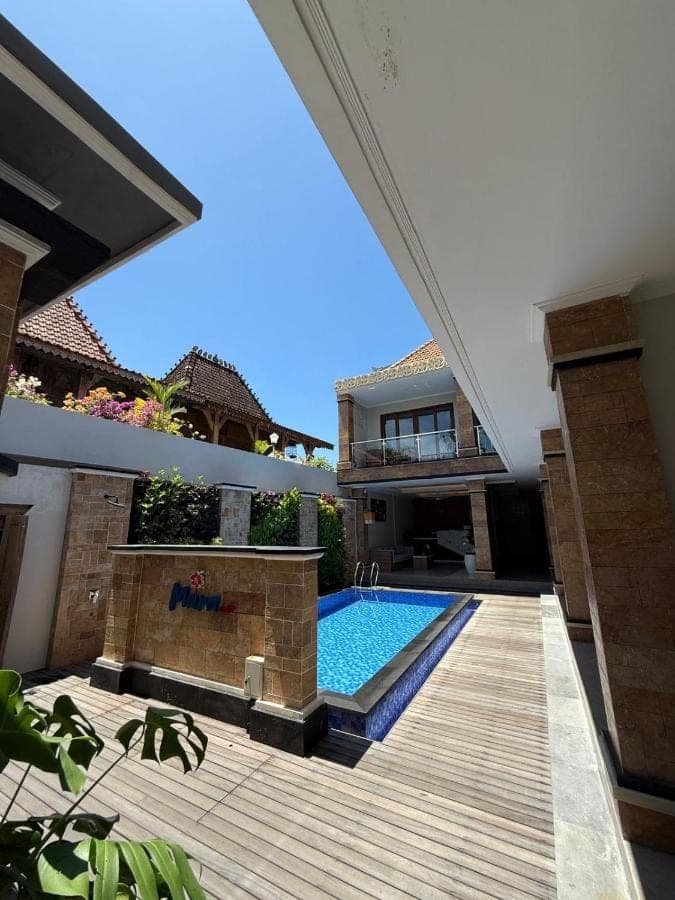 a swimming pool in the backyard of a house at Mara inn in Nusa Dua