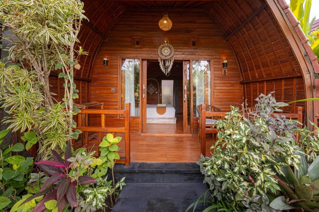 an entrance to a wooden house with a hallway at Cove Jiwana Villa in Nusa Dua
