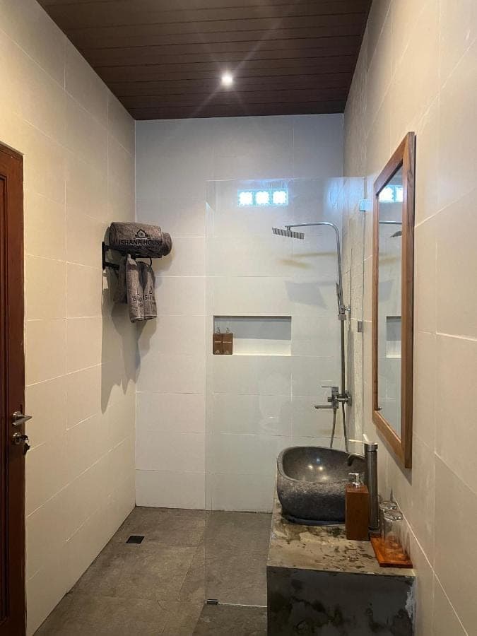 a bathroom with a sink and a mirror at Ishana House Padang-Padang in Uluwatu