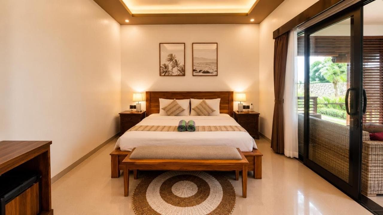 a bedroom with a bed and a window at Cahya Pandawa Villa in Nusa Dua
