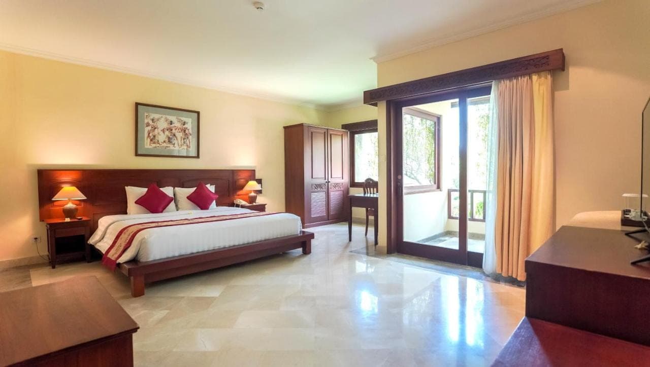 a bedroom with a bed and a large window at The Grand Bali Nusa Dua in Nusa Dua