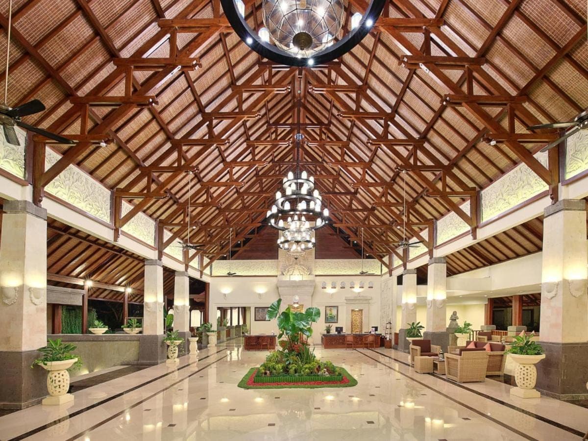 a lobby with a large building with a chandelier at The Grand Bali Nusa Dua in Nusa Dua