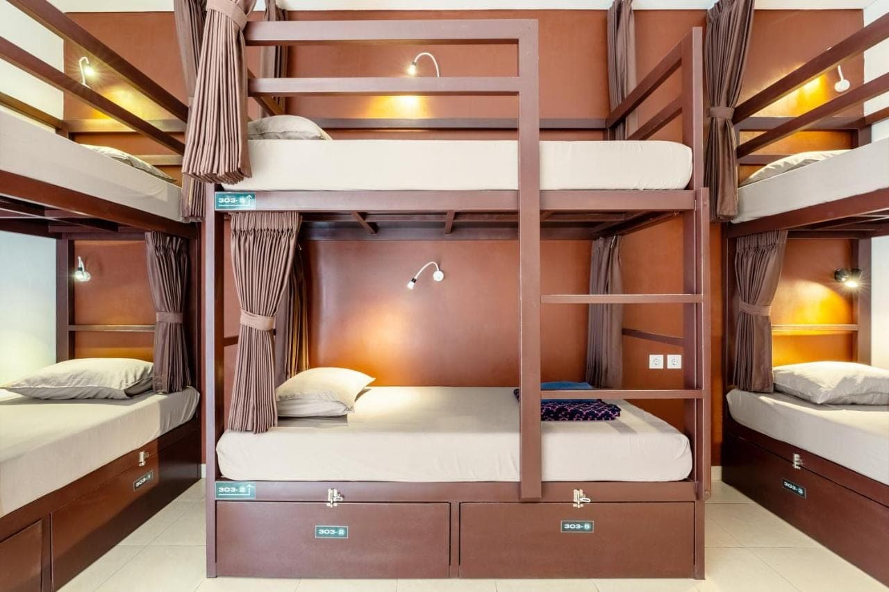 a bunk bed room with three bunk beds at Gelatik Bed And Breakfast in Seminyak