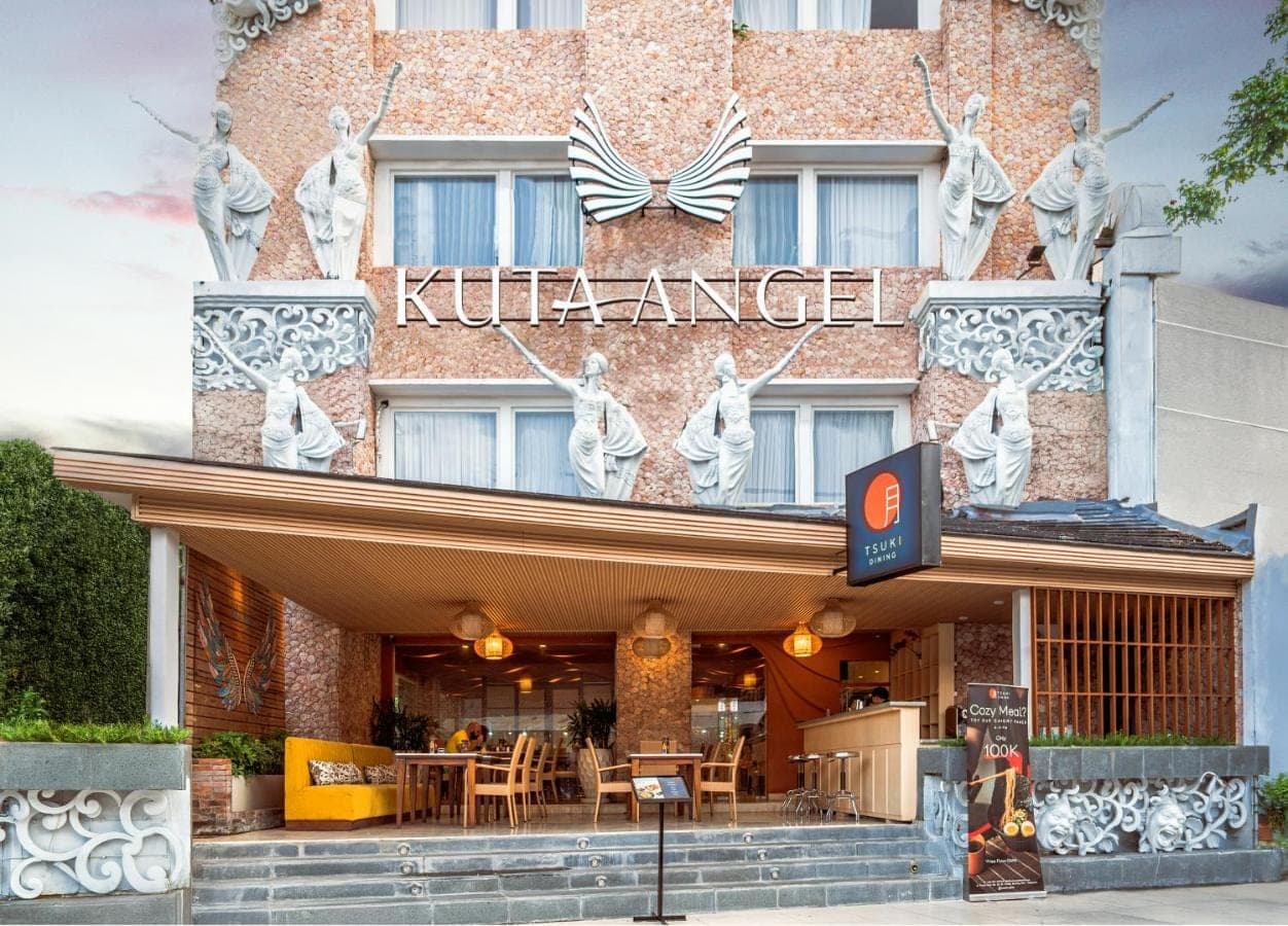 a kilt palace hotel with a sign on the front of it at Kuta Angel Hotel in Kuta