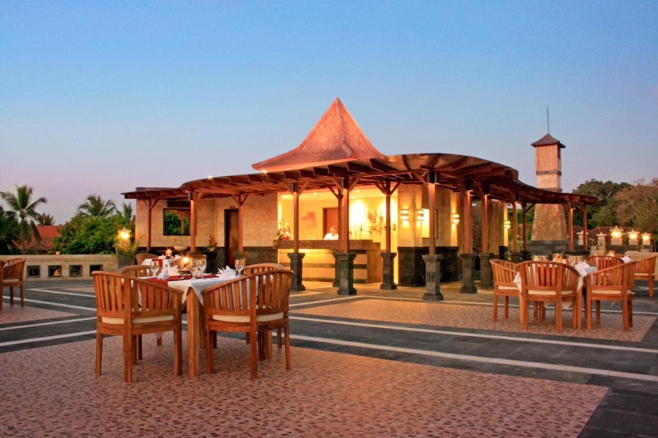 a restaurant with a gazebo with tables and chairs at Pelangi Bali Hotel & Spa in Seminyak