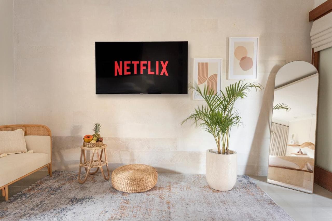 a living room with a netflix sign on the wall at Designer Studio Emy Sanur in Sanur