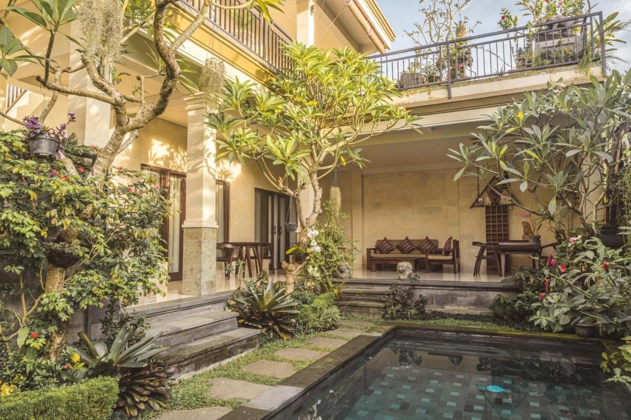 a house with a swimming pool in the yard at Divara Ubud in Ubud