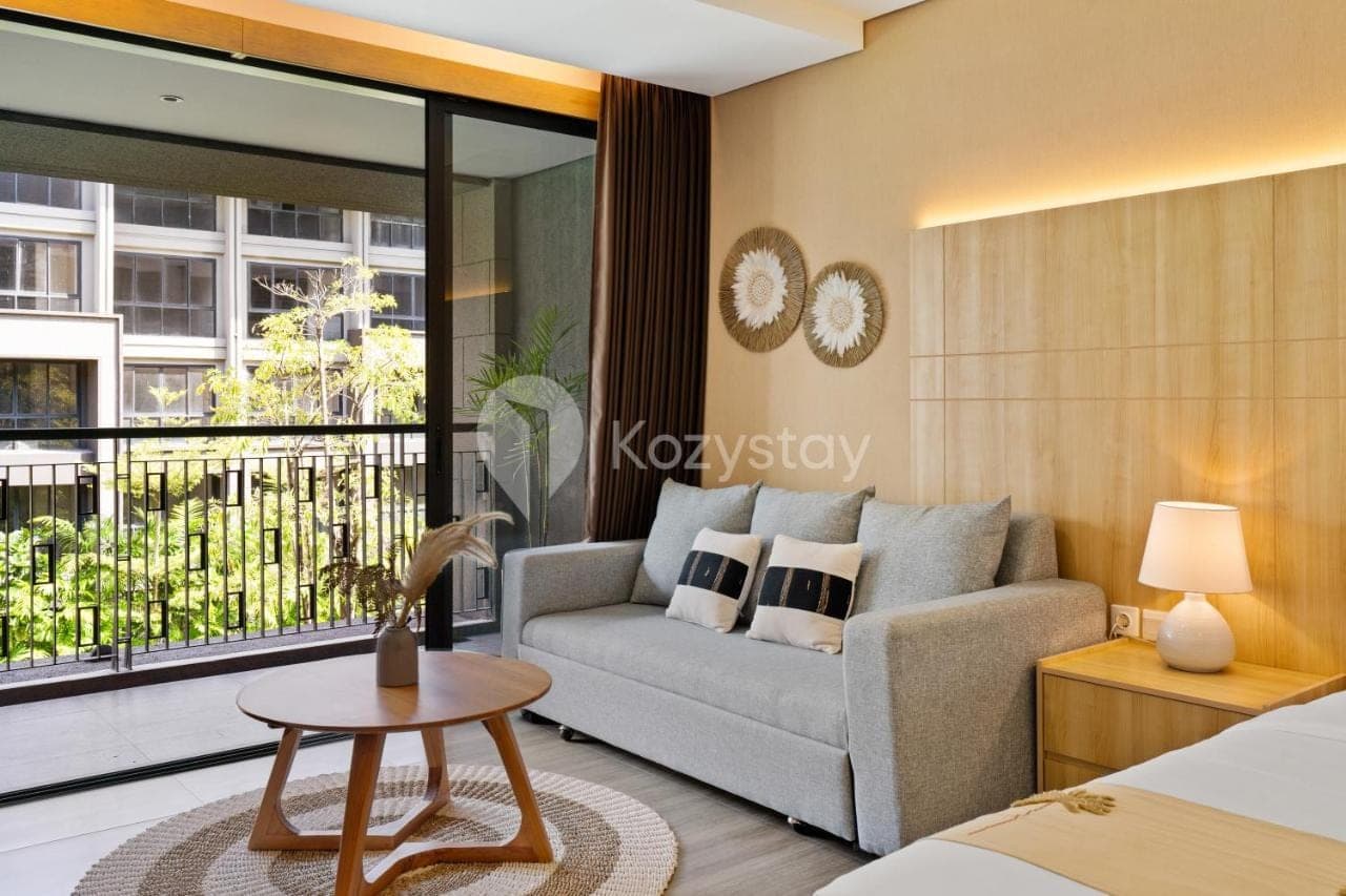 a living room with a couch and a table at Rivana by Kozystay - Nusa Dua in Nusa Dua