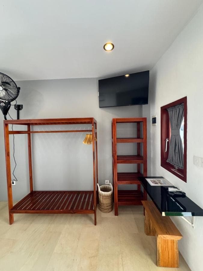 a room with a bed and a desk at Uluwatu Stay's Standard Room #1 in Uluwatu