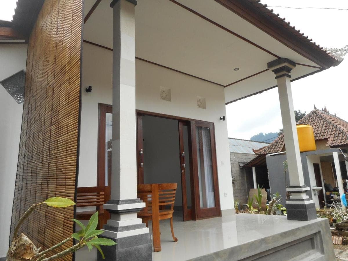 a house with a porch with chairs in it at New Lilastana Homestay in Sidemen