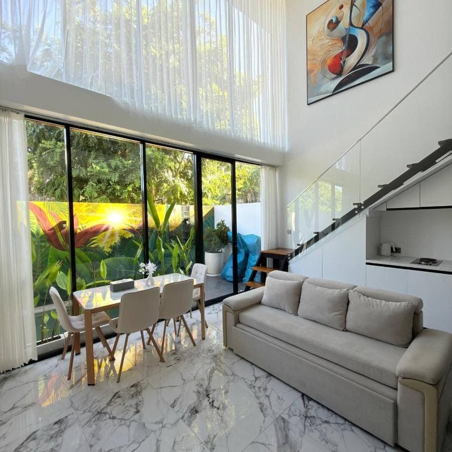 a living room with a couch and a table at Sun on The Hill By Betterplace in Nusa Dua