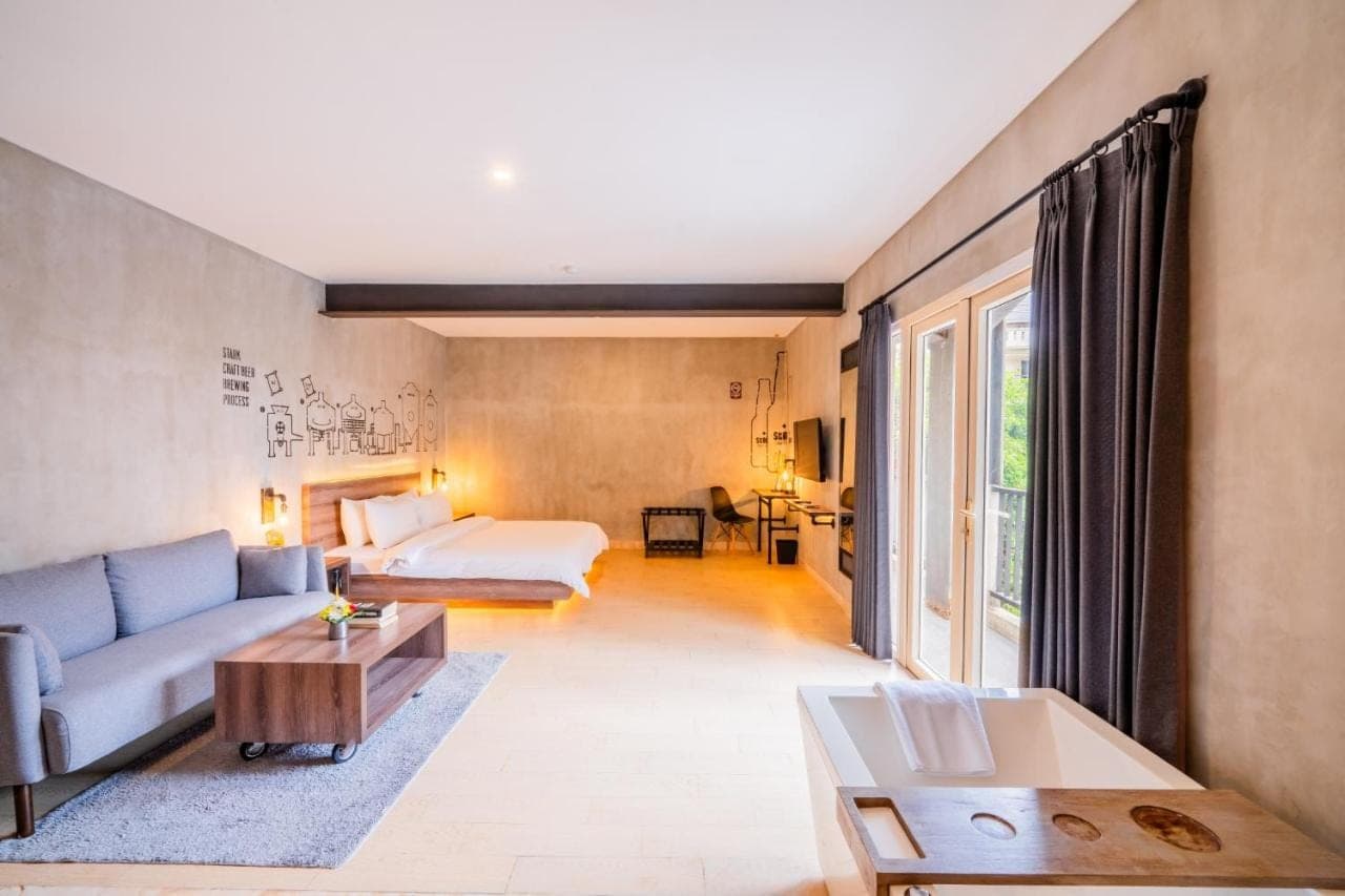 a living room with a couch and a bed at Stark Boutique Hotel and Spa in Kuta