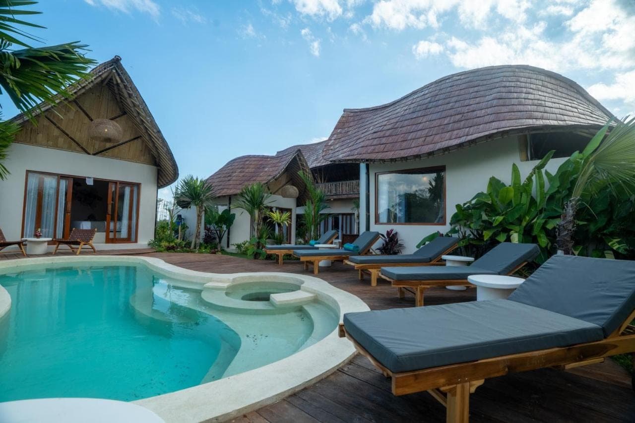a villa with a swimming pool and a house at Bamboo Layang Boutique Hotel, Rice Fields - Ubud in Ubud