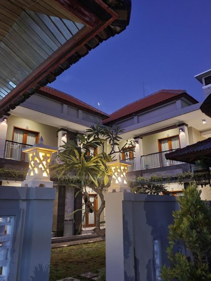 a house with a fence in front of it at Kalih Homestay Bali in Kuta