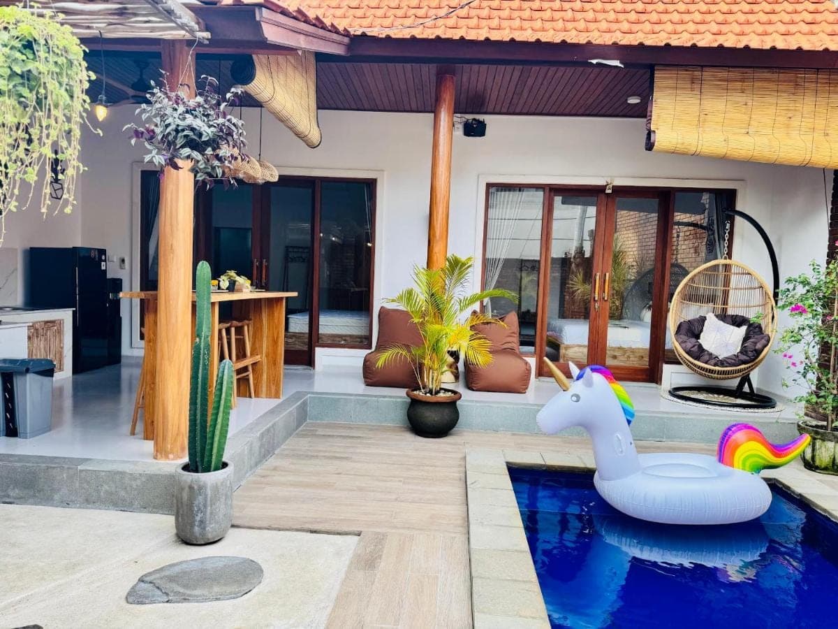 a villa with a pool and an inflatable unicorn in the yard at Nita Villa Bali in Canggu