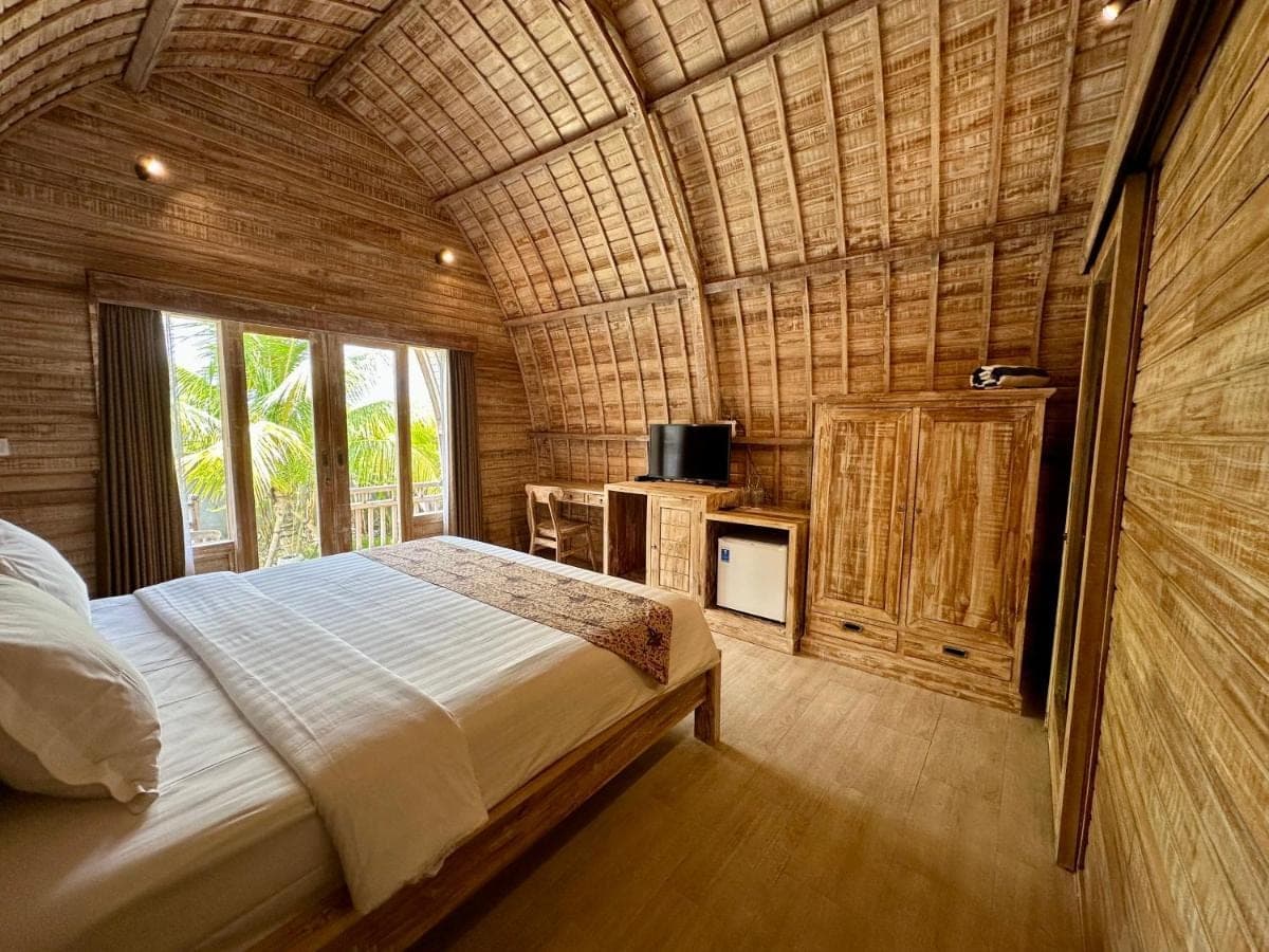 a bedroom with a large bed in a room at Tanhana Villa Canggu in Canggu