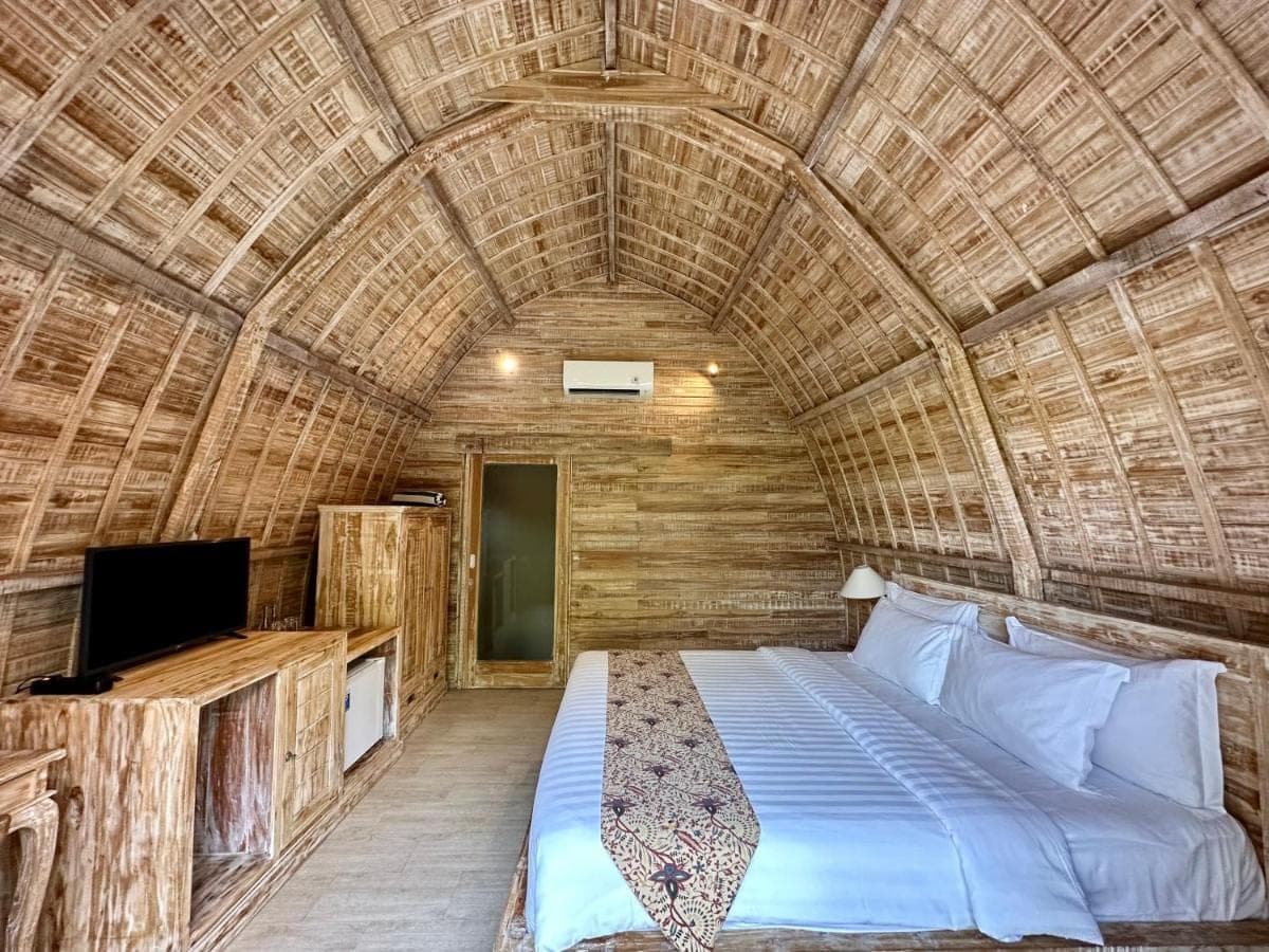 a bedroom with a bed in a wicker room at Tanhana Villa Canggu in Canggu