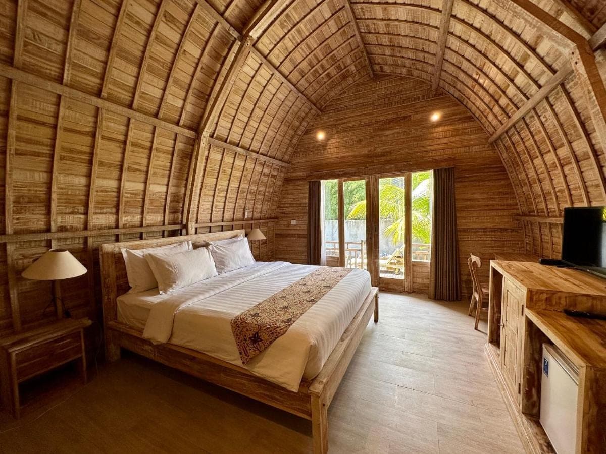 a bedroom with a bed in a wicker room at Tanhana Villa Canggu in Canggu