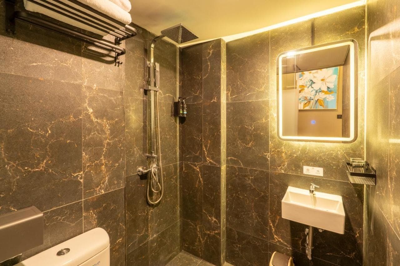 a bathroom with a toilet and a sink and a mirror at JJ JIVANA Bali in Canggu