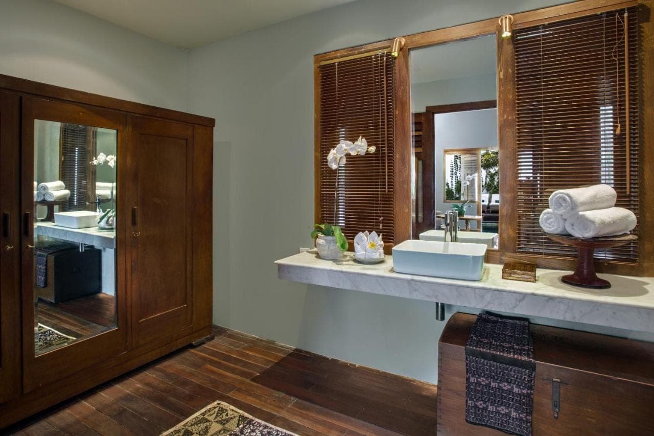 a bathroom with a sink and a mirror at Room & Vespa 3 - Relaxing Stay Center Seminyak in Seminyak