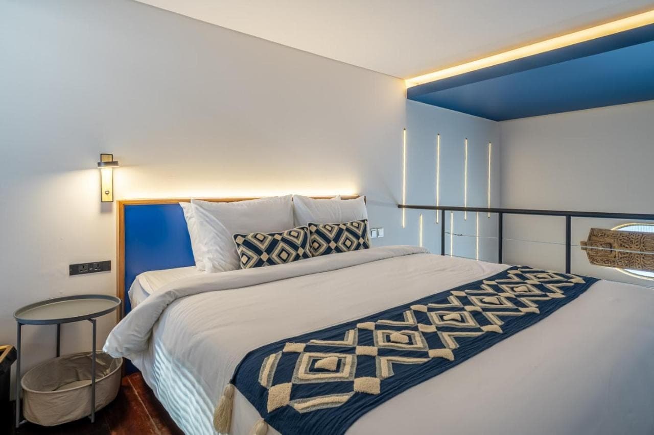 a bedroom with a large bed and a window at First 5 Loft near Seminyak in Seminyak