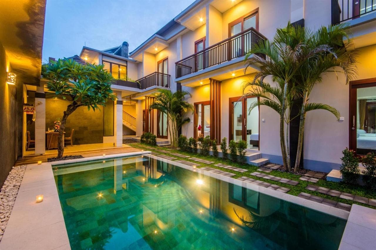 a house with a swimming pool in front of it at Valka Bali Boutique Hotels in Seminyak