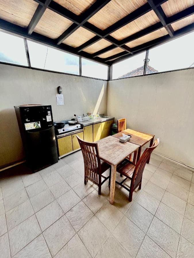 a kitchen with a table and chairs in a room at Valka Bali Boutique Hotels in Seminyak