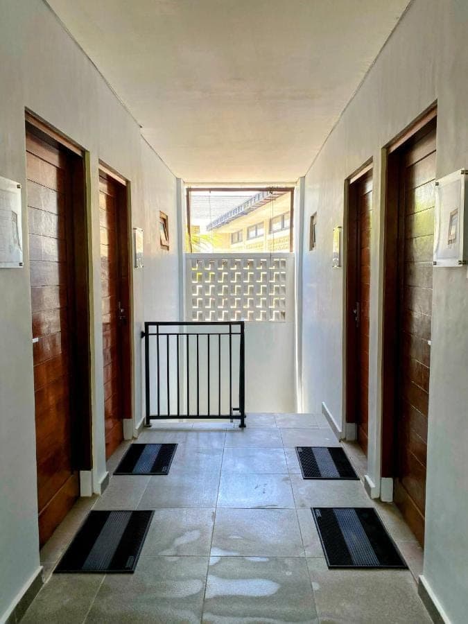 a hallway with doors and a window in a building at Gatsby Hotel Hostel in Uluwatu