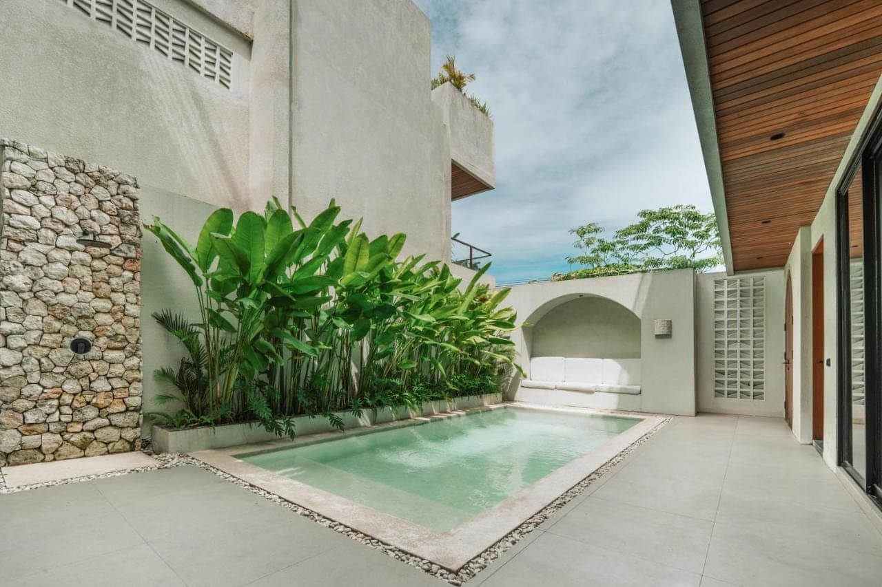an indoor swimming pool in the backyard of a house at Adaya Boutique Villas in Uluwatu