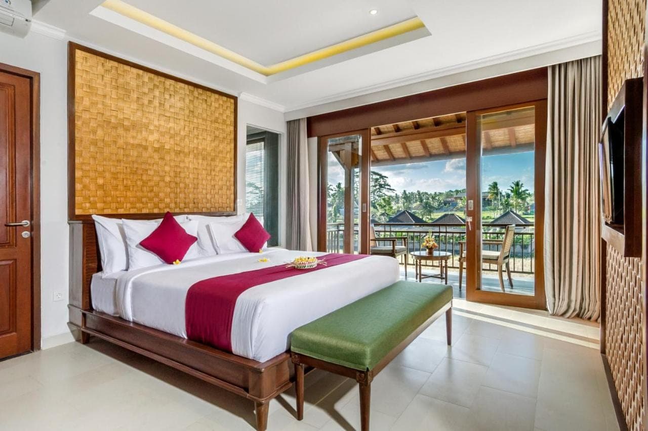 a bedroom with a large bed and a balcony at Bumi Muwa Ubud Katiklantang in Ubud