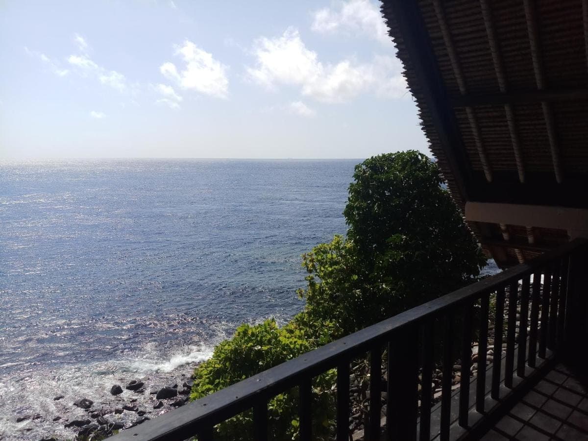 a view of the ocean from the balcony of a house at Amed Santorini Villa in Amed