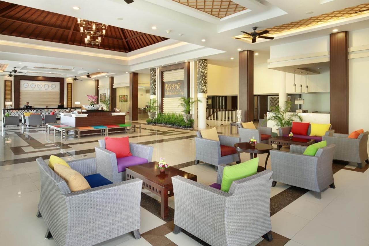 a lobby of a hotel with colorful chairs and tables at Bali Relaxing Resort and Spa in Nusa Dua