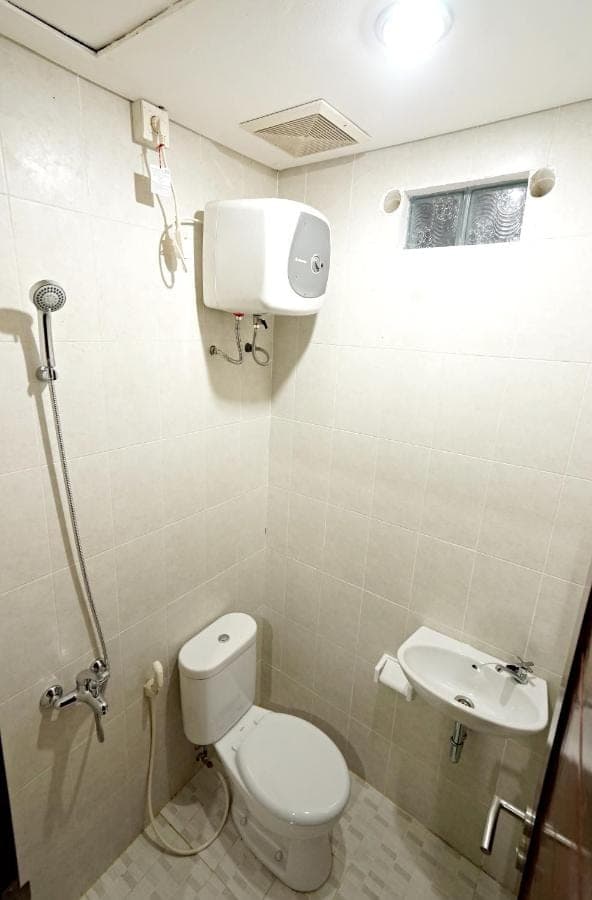 a bathroom with a toilet and a sink at D'Pande Kuta in Kuta