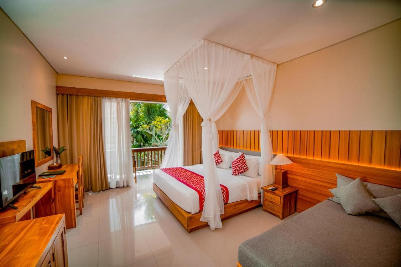 a bedroom with a bed with a mosquito net at Pertiwi Bisma Ubud in Ubud
