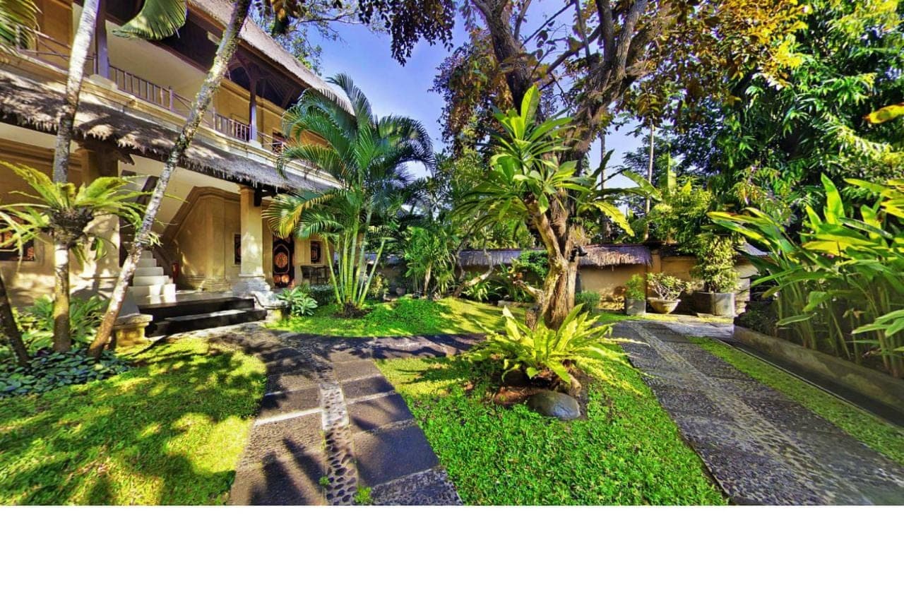 a courtyard of a house with trees and plants at Bali Agung Village in Seminyak