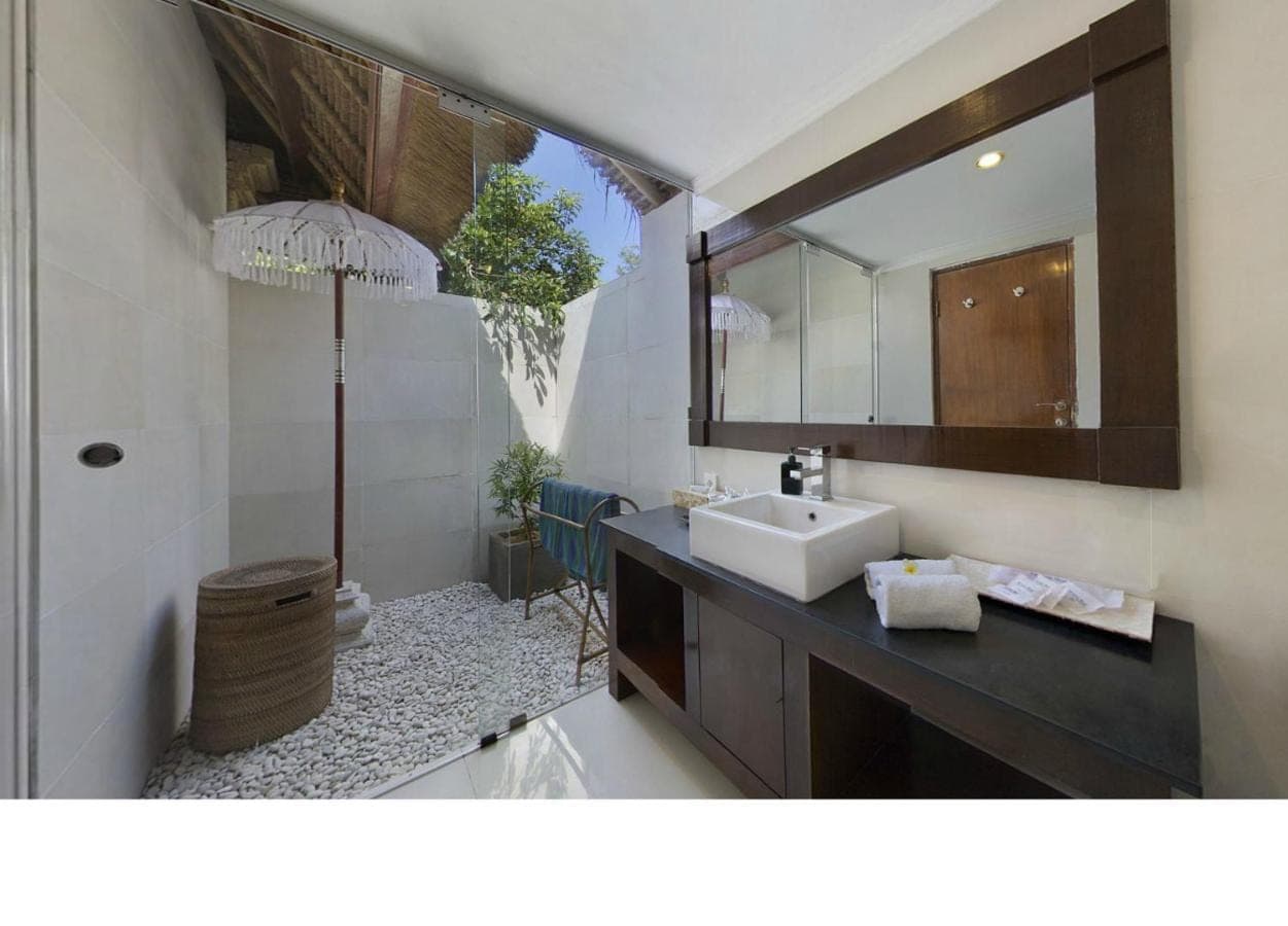 a bathroom with a sink and a mirror at Bali Agung Village in Seminyak