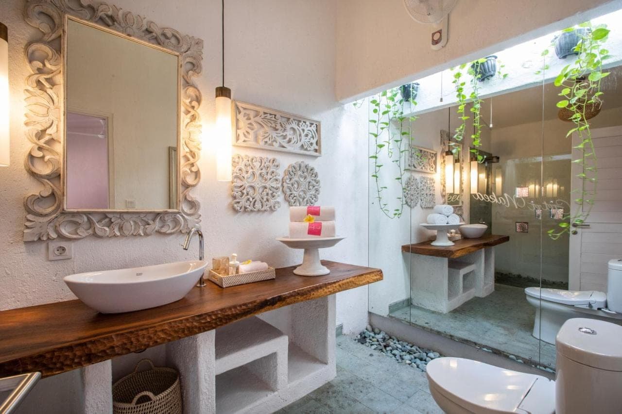 a bathroom with a sink and a toilet and a shower at PinkPrivate Sanur - for Cool Adults Only in Sanur
