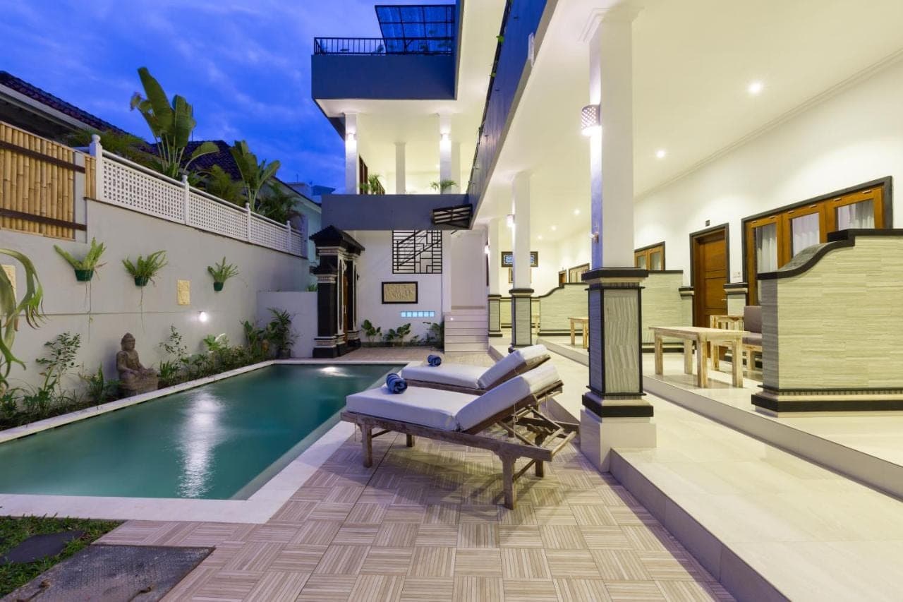 a house with a swimming pool and a patio at Amerta Seminyak in Seminyak