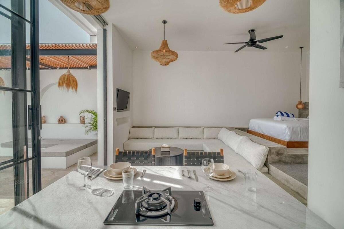 a living room with a table and a couch at Avasa Villas - Brand New 1BR Luxury in Canggu in Canggu