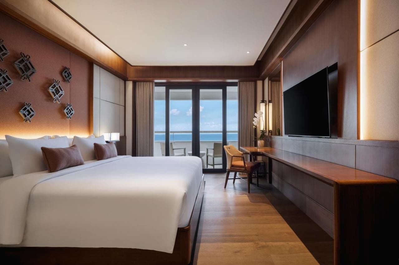 a hotel room with a large bed and a television at Bali Beach Hotel in Sanur