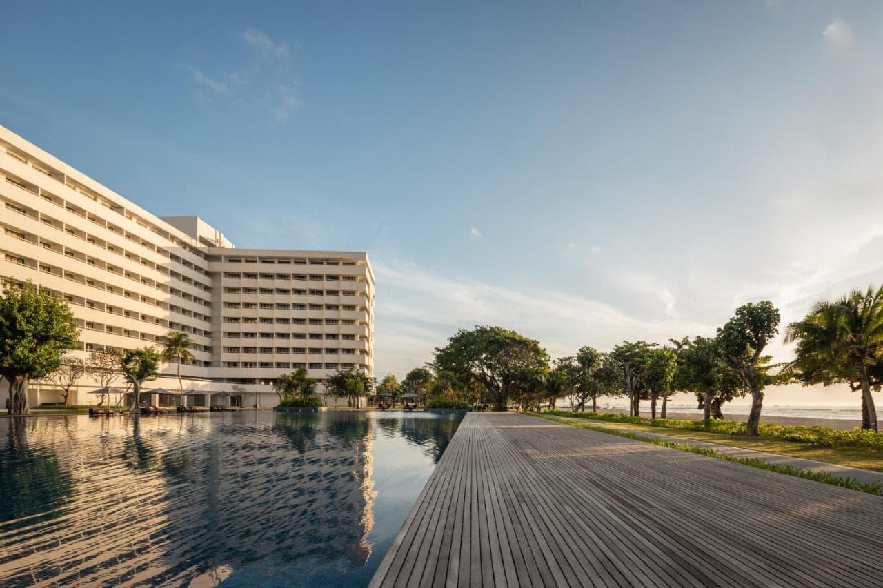 a view of a building and a pool of water at Bali Beach Hotel in Sanur