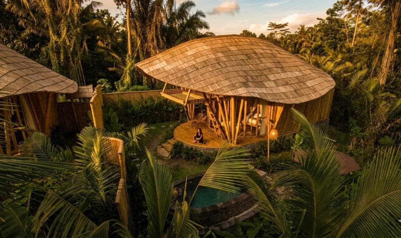 a resort with atropical building with a pool at Phoenix Bamboo House by Ecobreeze in Sidemen