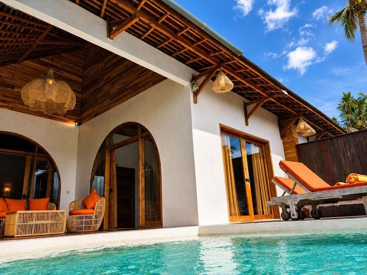 a villa with a swimming pool and a house at Les Mandarines - Rice fields & jungle retreat in Ubud