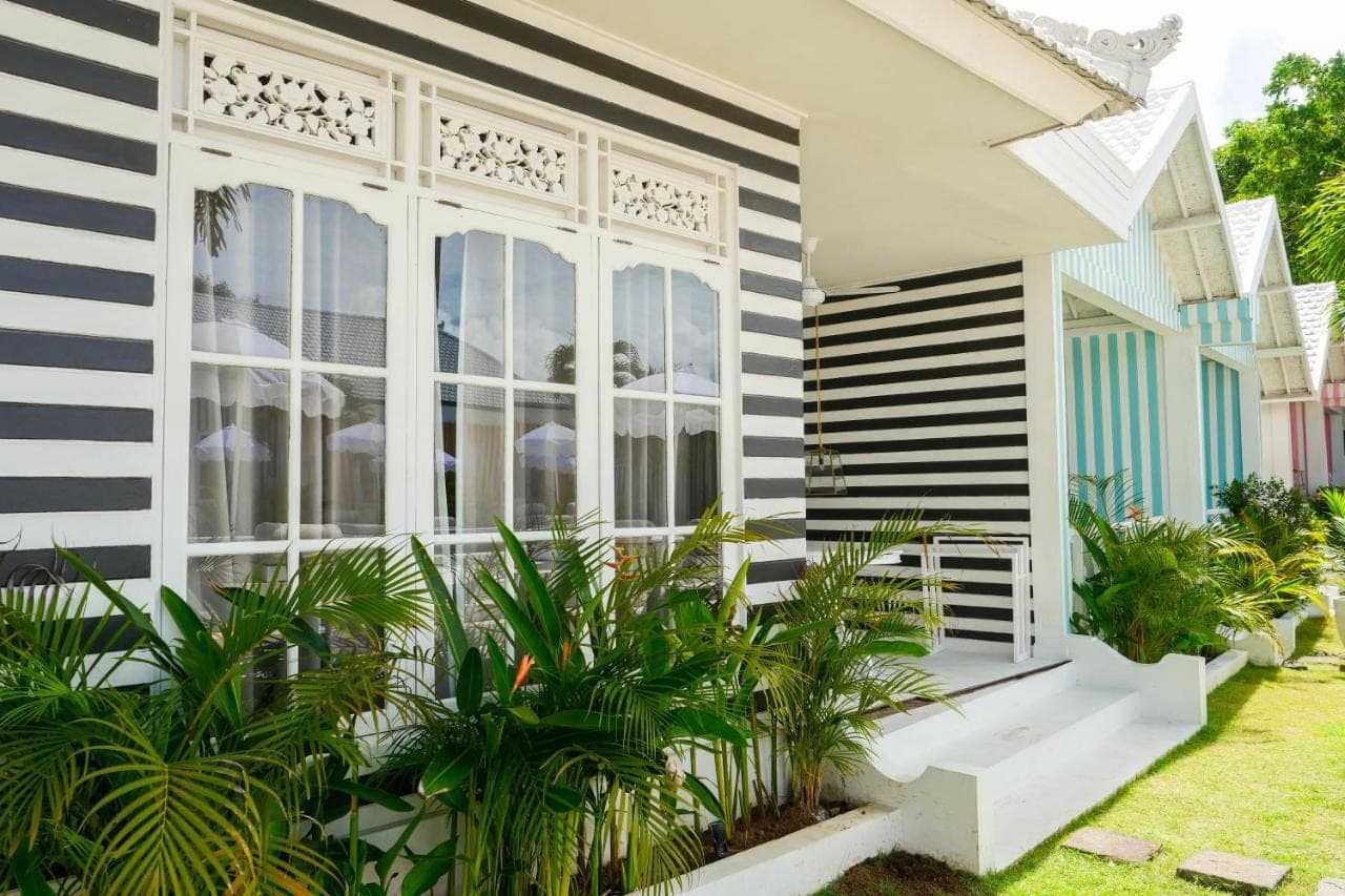 a house with black and white stripes at Ria Uluwatu, Tropical Chic Hotel in Uluwatu