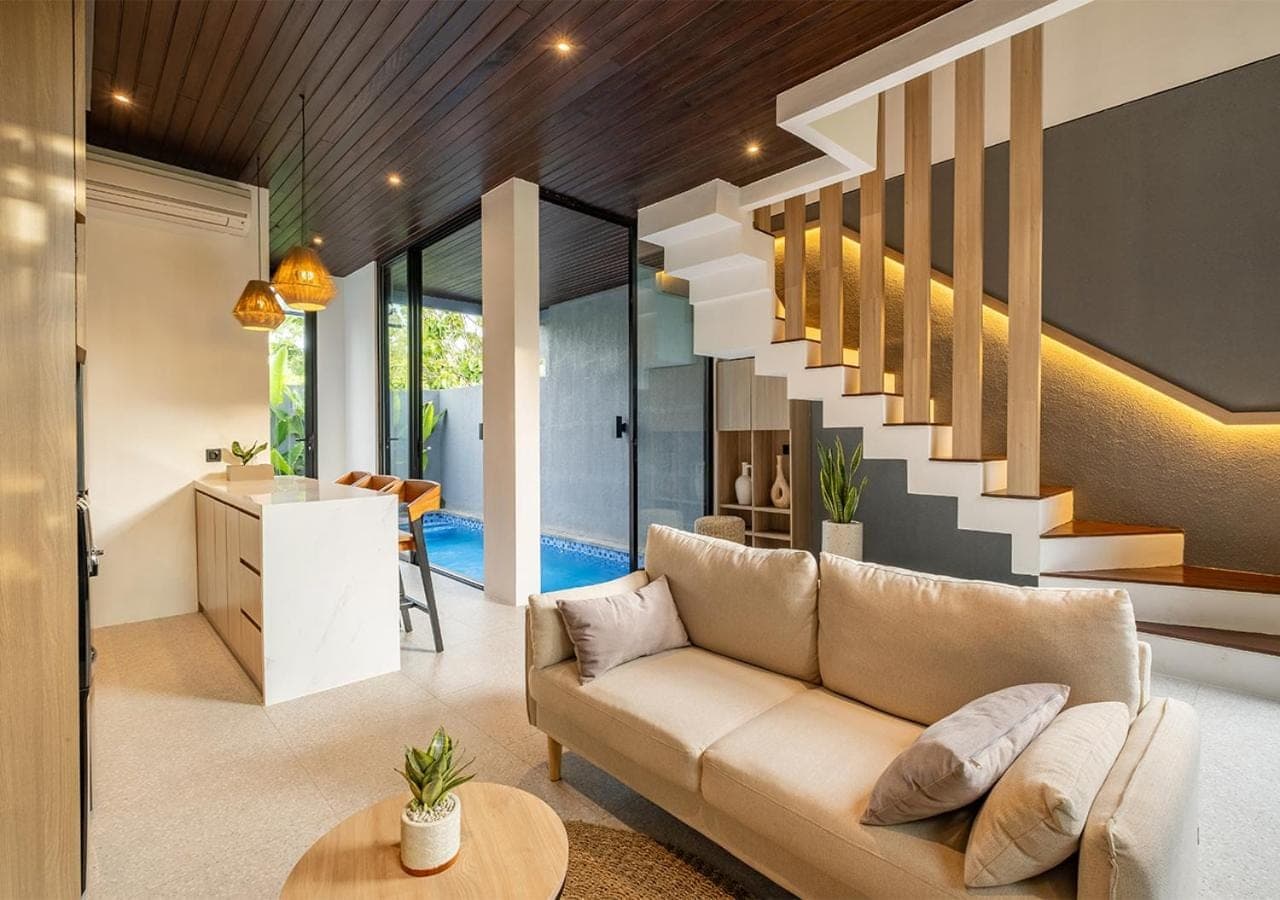 a living room with a couch and a staircase at Private Villa Ayra 8B by OriVista 10min to Melasti Beach in Uluwatu