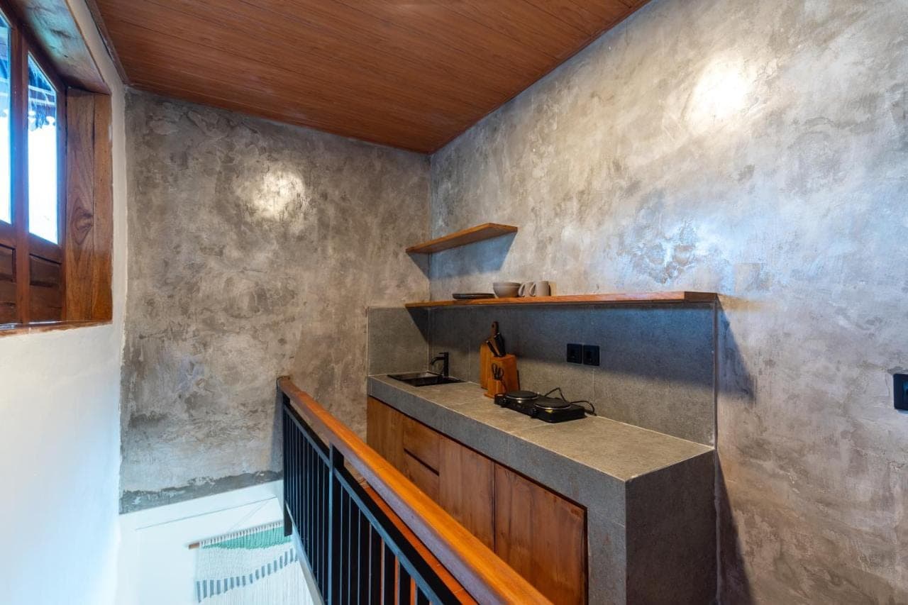 a kitchen with a counter in a room at Erira House Ubud in Ubud