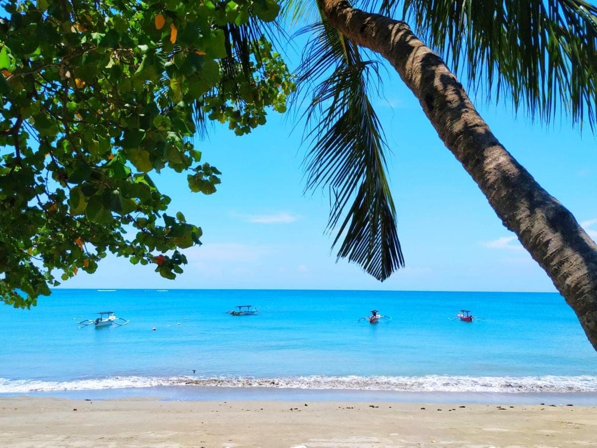 a view of the beach with boats in the water at The Patra Bali Resort & Villas - CHSE Certified in Kuta