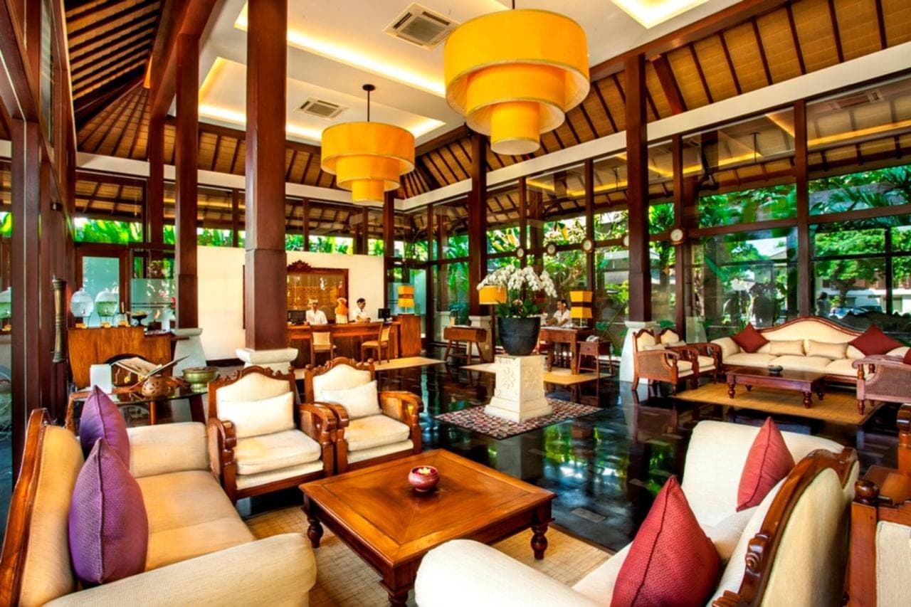 a lobby of a resort with couches and tables at Rama Beach Resort and Villas in Kuta