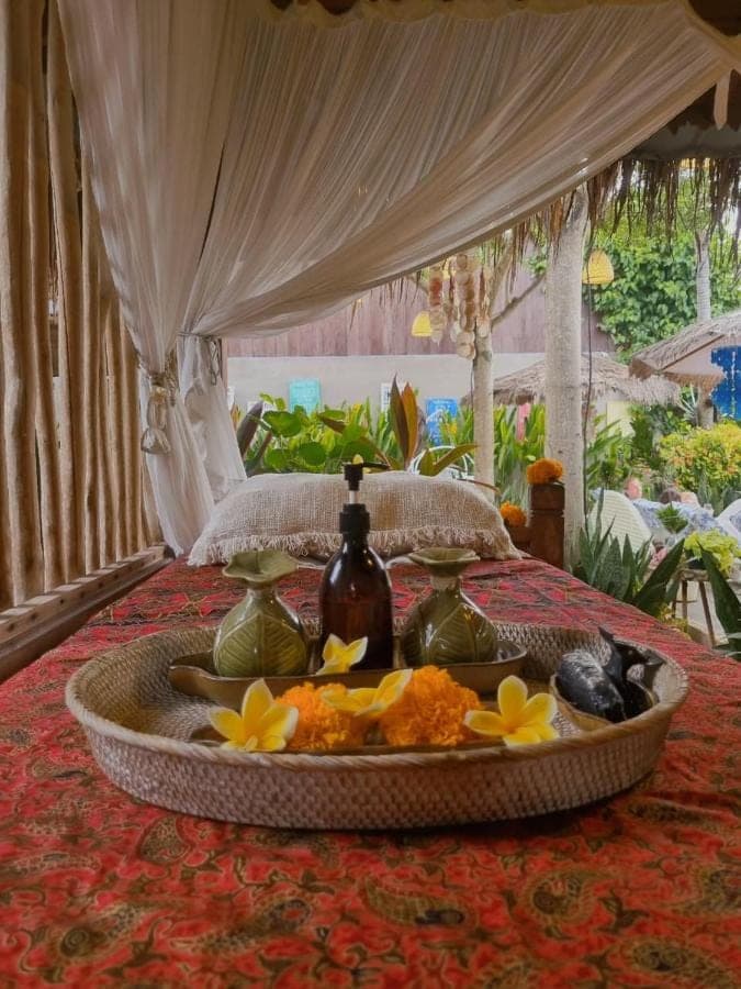 a tray of food sitting on top of a bed at Kubu Dimel Suites and Villas Resort in Nusa Dua
