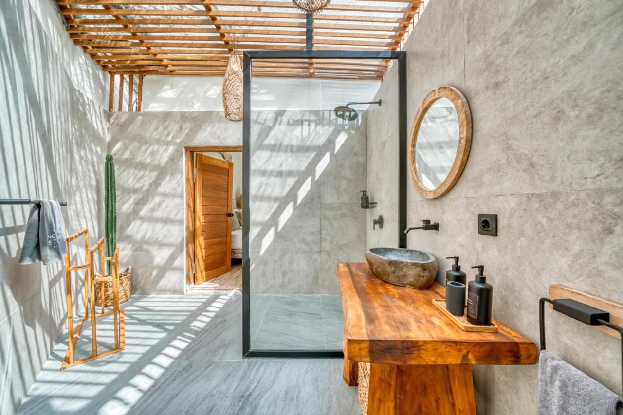 a bathroom with a sink and a mirror at Noho Stay Bali in Uluwatu